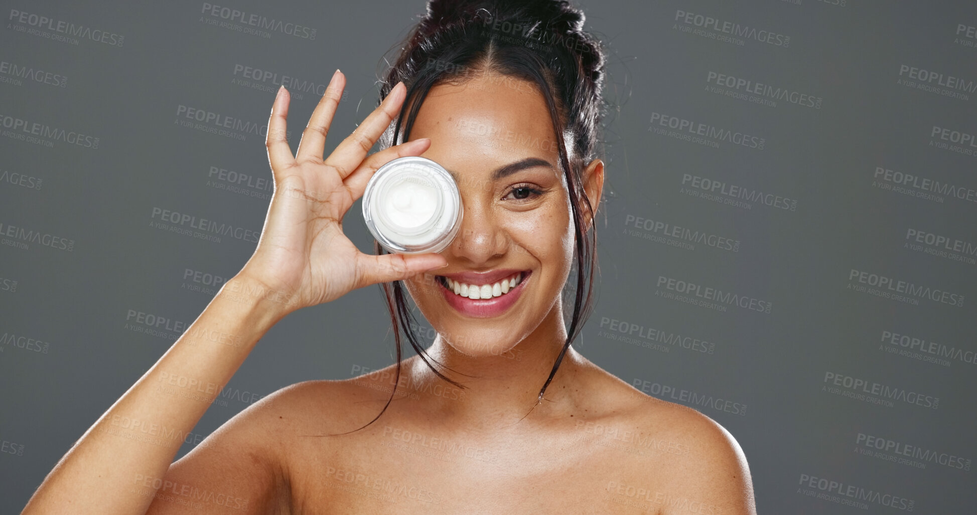 Buy stock photo Happy woman, face and cream for skincare, beauty or cosmetics against a grey studio background. Portrait of female person smile with moisturizer, creme or lotion for facial treatment or product