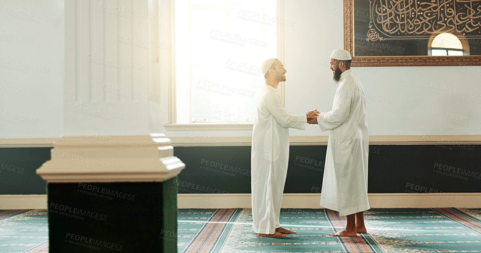 Buy stock photo Muslim, handshake and people in mosque for greeting, conversation and respect in Islamic community. Worship, friends and men shaking hands in religious building for Ramadan Kareem, prayer and support