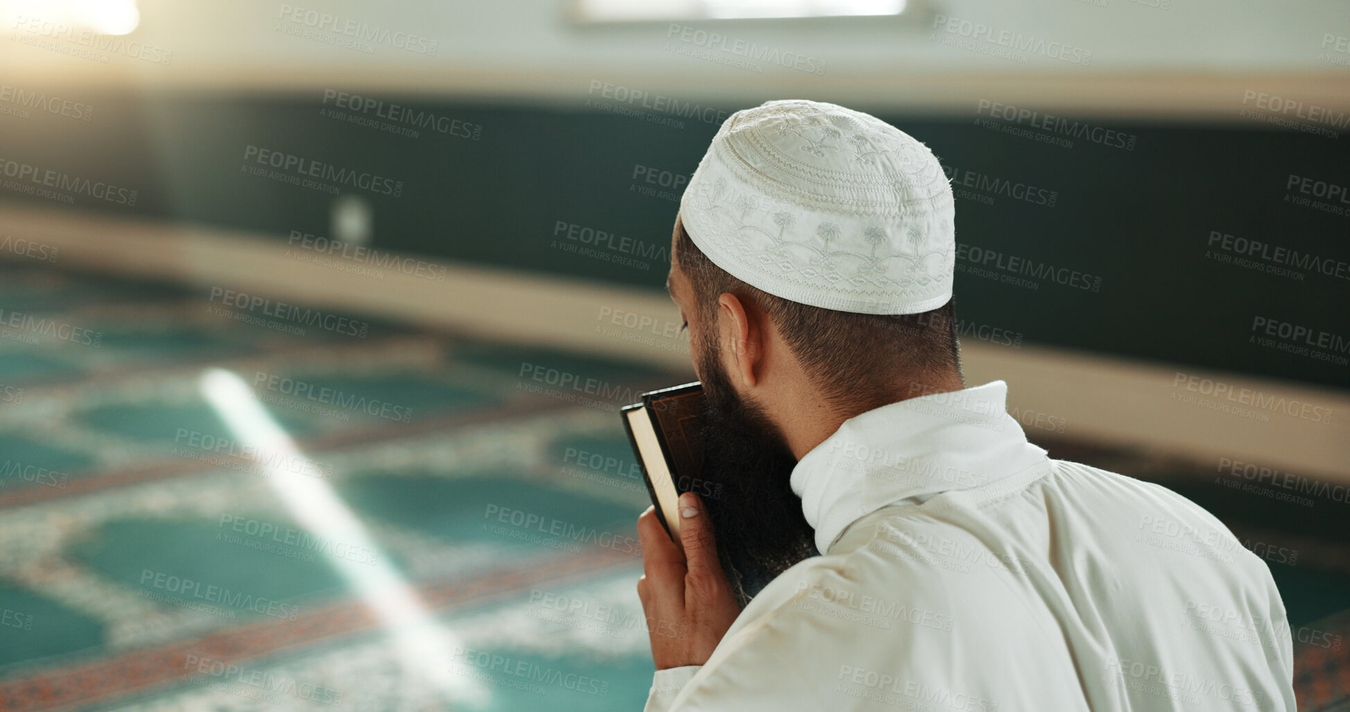 Buy stock photo Islamic man, kiss quran and mosque for faith, reading or mindfulness with worship, praise or back for study. Muslim person, religion and peace in book, prayer or thinking with meditation in Palestine