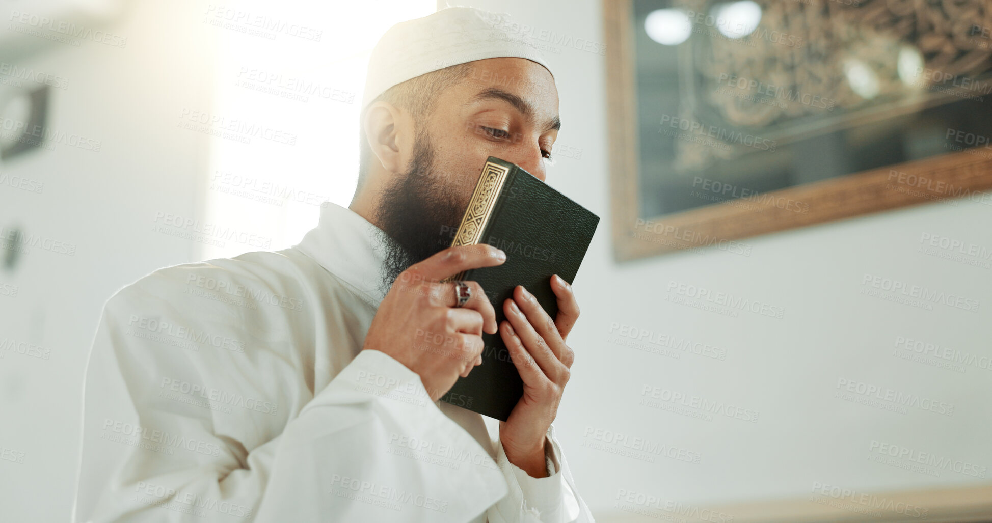 Buy stock photo Islam, kiss and man in mosque with Quran, mindfulness and gratitude in faith reading. Worship, religion and love, Muslim Imam in holy temple for praise, spiritual teaching and peace in prayer at Eid.