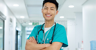 Face, doctor and confident with smile in hospital with arms crossed for leadership in medicine. Asian man, person or nurse in cardiology, emergency care or health for treatment of patient at clinic