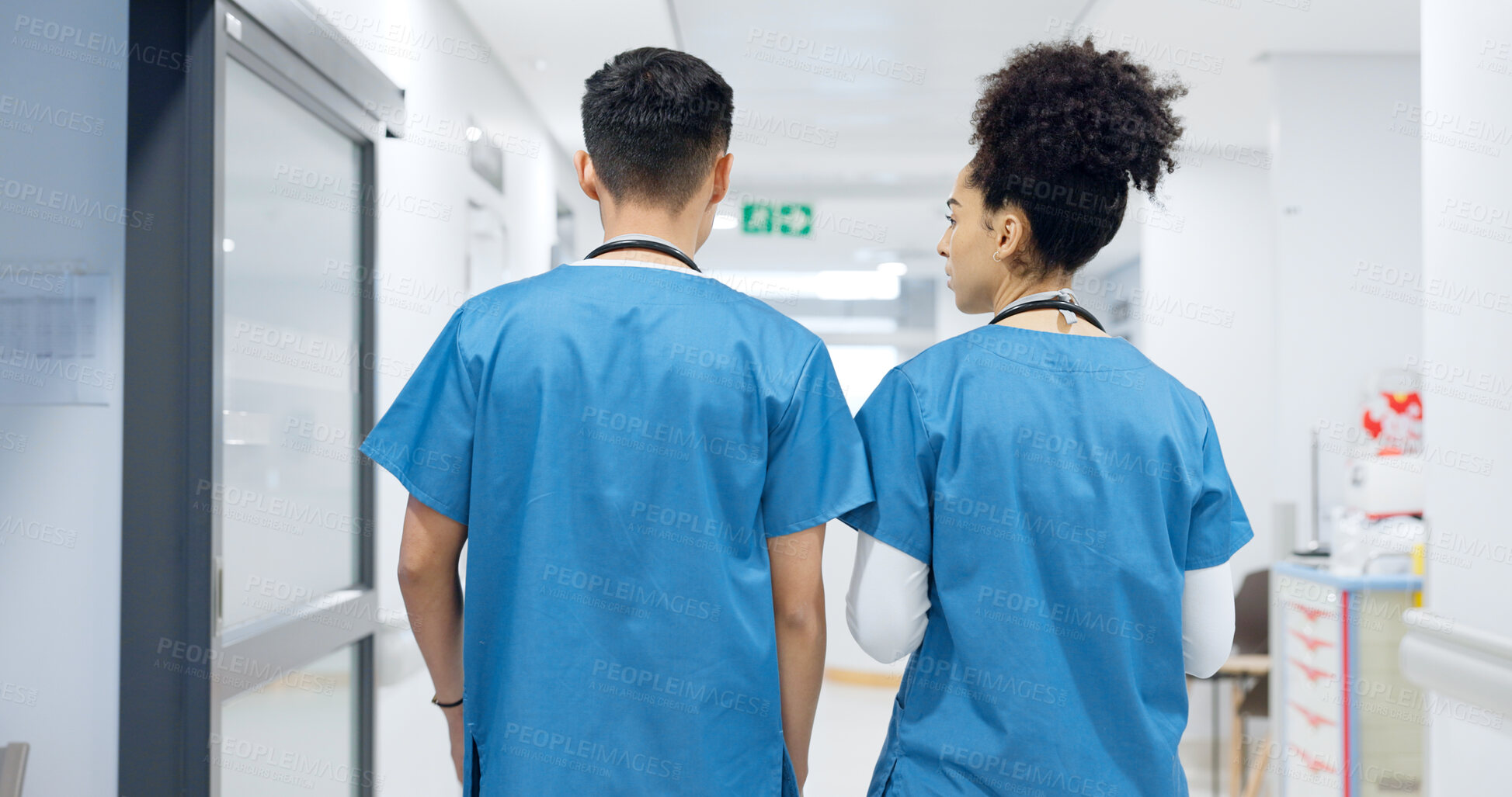 Buy stock photo Doctors, man and woman in hallway, talking and partnership with back, discussion and ideas in clinic. Medic, nurse or surgeon teamwork with planning, brainstorming or problem solving in hospital