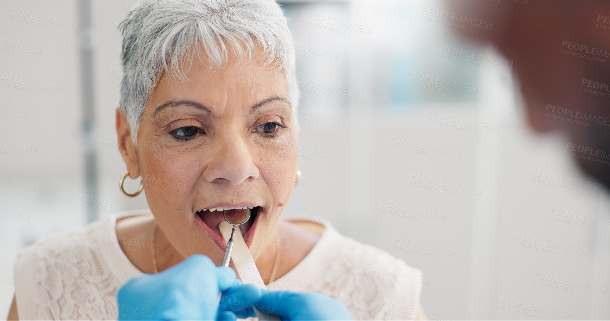 Buy stock photo Patient, doctor and tongue depressor for throat assessment in clinic for respiratory infection, inflammation or wellness. Elderly woman, man and mirror for healthcare consultation, diagnosis or exam