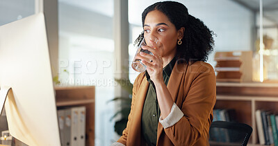 Woman at desk with computer, drinking water and typing email, report or article at digital agency. Internet, research and happy businesswoman at tech startup with glass, networking or project at work