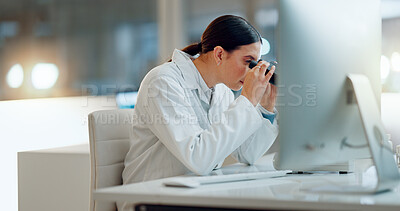 Science, research and woman with microscope, computer and typing data report in laboratory. Medical innovation, scientist or lab technician in study for healthcare, medicine and vaccine test feedback