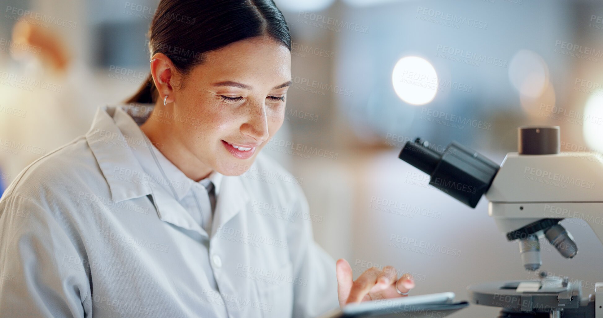 Buy stock photo Scientist, woman and tablet, microscope or laboratory research for DNA analysis and happy with medical study. Student or science expert in biotechnology with digital software and lens check for data