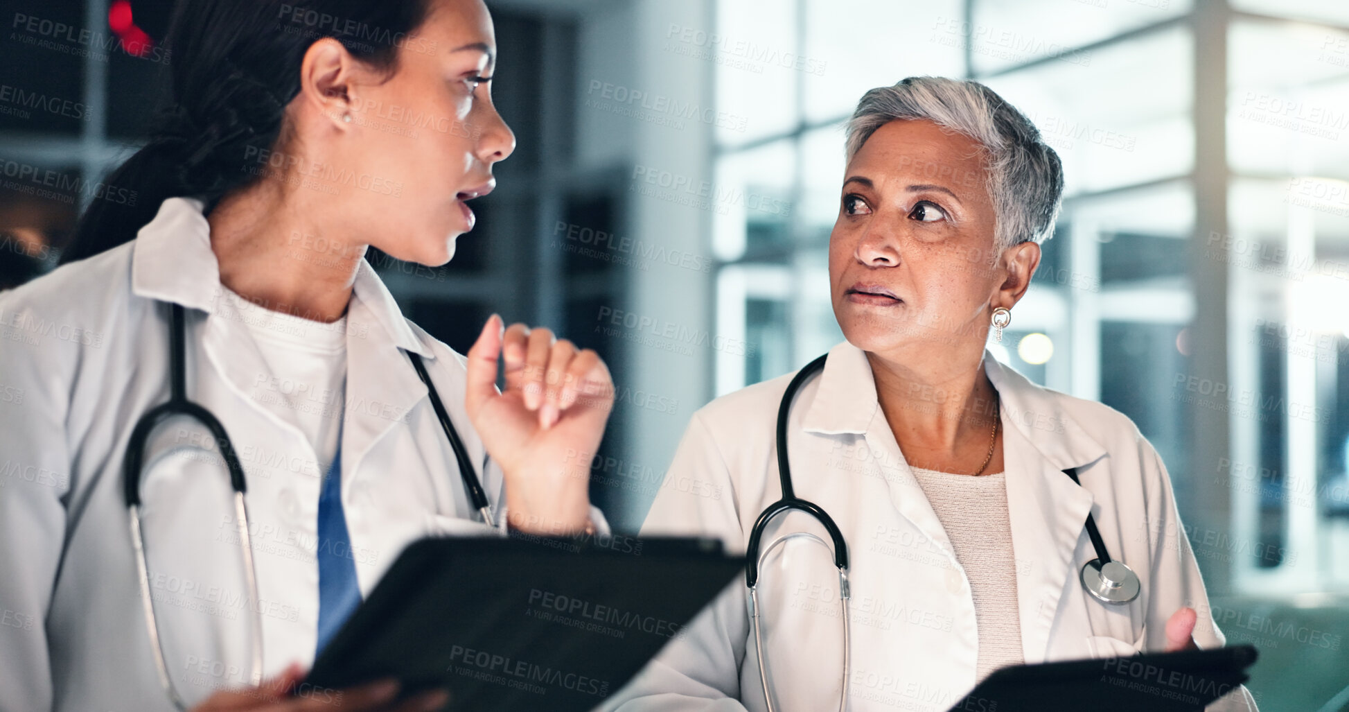 Buy stock photo Doctors night planning and tablet with talking, medical data and research in a hospital with women. Working, online and diagnosis discussion for healthcare, wellness and clinic job with conversation