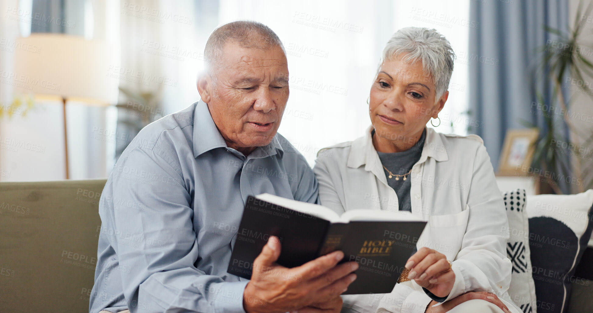 Buy stock photo Senior, couple and home reading bible and talking of faith, god or helping with spiritual guide of scripture on sofa. Elderly man, pastor and christian woman with holy book for religion and support