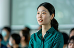 Businesswoman, conference or speaker sharing information at a business seminar for knowledge, motivational or coaching. Confident, woman or coach speaks to audience at a convention or corporate event