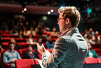Businessman, conference or speaker sharing information at a business seminar for knowledge, motivational or coaching. Confident, man or coach speaks to audience at a convention or corporate event