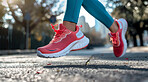 Female, running and athlete exercise in the morning for marathon competition, training or jogging workout alone. Low angle, sunrise and sport woman shoes mockup for challenge, technology or fitness