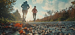 Group, running and athlete exercise on an open road for marathon competition, training or jogging workout together. Low angle, sunrise and sport shoes mockup for challenge, activity or team support