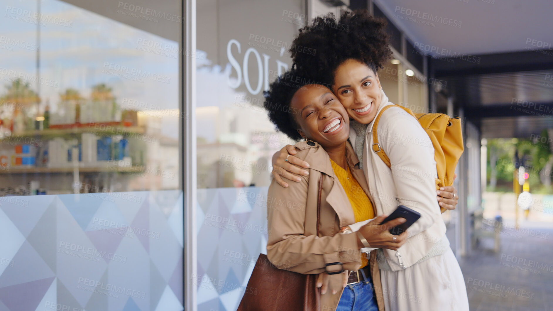 Buy stock photo Excited, women and friends hug in city for care, support or greeting together for bonding at street. Girls, smile and embrace for reunion, meeting and funny African people laugh outdoor in urban town