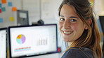 Computer, business and woman in an office for marketing strategy, data analysis and infographics on screen. Happy, confident and American sitting at her desk for finance, professional and technology