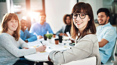 Buy stock photo Portrait of a young designer sitting in the boardroom with her colleagues