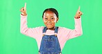 Children, pointing and a black girl on a green screen background in studio for marketing a product. Kids, portrait and advertising with a cute little female child showing space on chromakey mockup