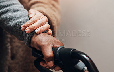 Buy stock photo Shot of an unrecognizable senior woman helping her husband to walk with his walker