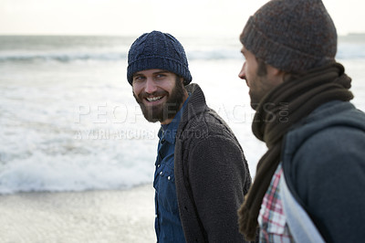 Buy stock photo Travel, friends and smile with men at the beach for adventure, vacation and relax. Happy, calm and winter with people walking at seaside for holiday trip, nature and outdoor journey together