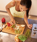 Cooking, food and chef with woman in kitchen of home to prepare meal for diet or nutrition from above. Health, nutritionist or vegan and hands of person with ingredients for recipe in apartment
