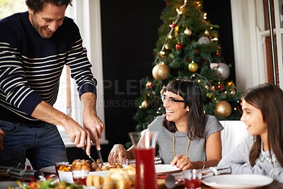 Buy stock photo Family, Christmas and man cutting turkey for festive lunch, bonding and eating together in home. Holiday, celebration and happy people at table with food, drinks and xmas dinner tradition with smile