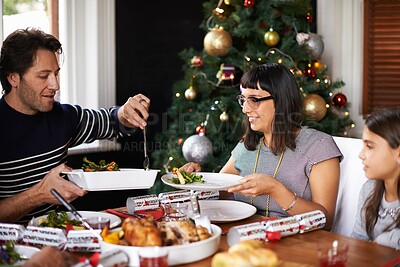 Buy stock photo Christmas, family and parents with child in home for dinner, lunch and eating together for festival. Mother, father and girl with food for holiday, vacation and festive celebration at dining table