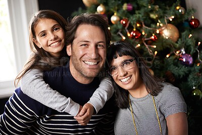 Buy stock photo Christmas, family and portrait of parents with girl in home for celebration, festival and season event. Happy mom, dad and child bonding, relax and embrace for holiday, vacation and festive party
