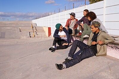 Buy stock photo Skate park, diversity and friends with conversation, sunshine and relaxing with discussion and happiness. Multiracial, gen z and team on a break, summer and bonding together with skaters and group