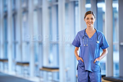 Buy stock photo Portrait of a happy young doctor standing in a hospital hallway