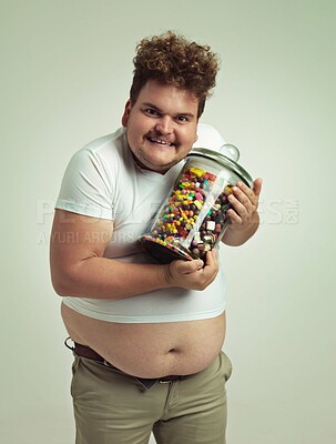Buy stock photo Candy, jar and portrait of crazy man in studio for snacks, sweets and dessert in container. Comic, funny and overweight, isolated and plus size person with glass for unhealthy diet on background