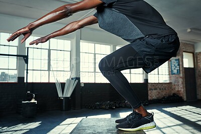 Buy stock photo Shot of an unrecognizable man doing jumping exercises on a wooden block in a gym