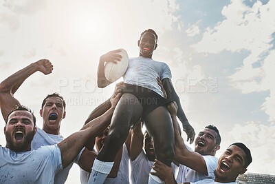 Buy stock photo Portrait of a group of cheerful young rugby players celebrating their win by lifting one of their teammates