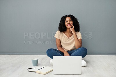 Buy stock photo Studio shot of a young woman using a laptop while completing her studies against a gray background