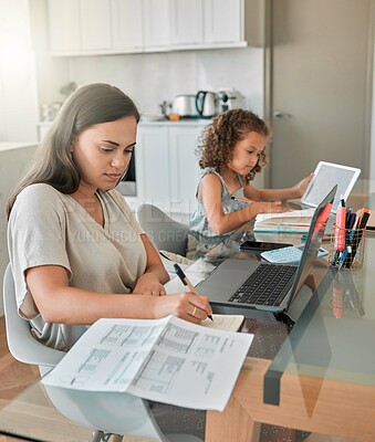 Buy stock photo Mother and daughter being productive with remote work and homework, multitasking at a kitchen table at home. Parent and child serious while paying bills and watching an online education programme