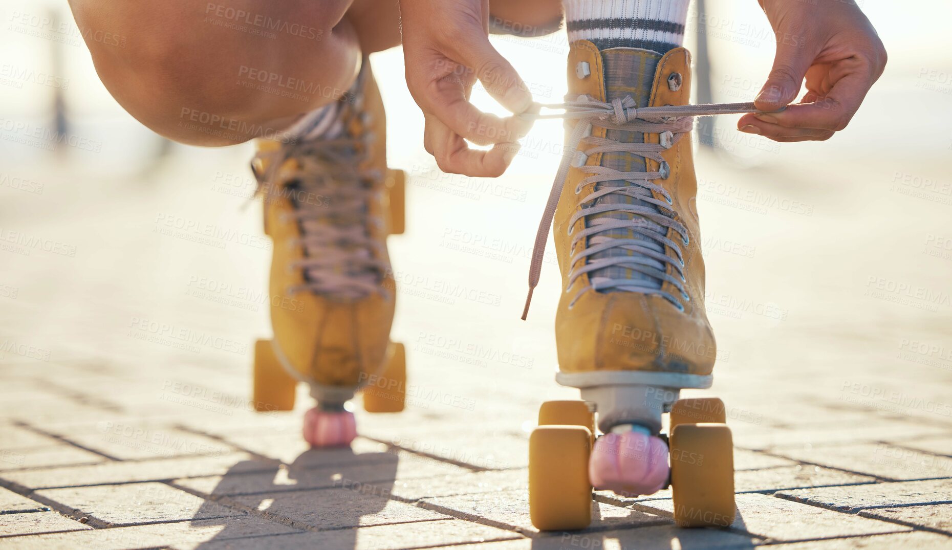 Buy stock photo Yellow roller skates shoes of woman in summer outdoor travel, journey or fun activity for the holiday. Cool, trendy or funky gen z person prepare or tie laces on ground in quad skating with sunshine