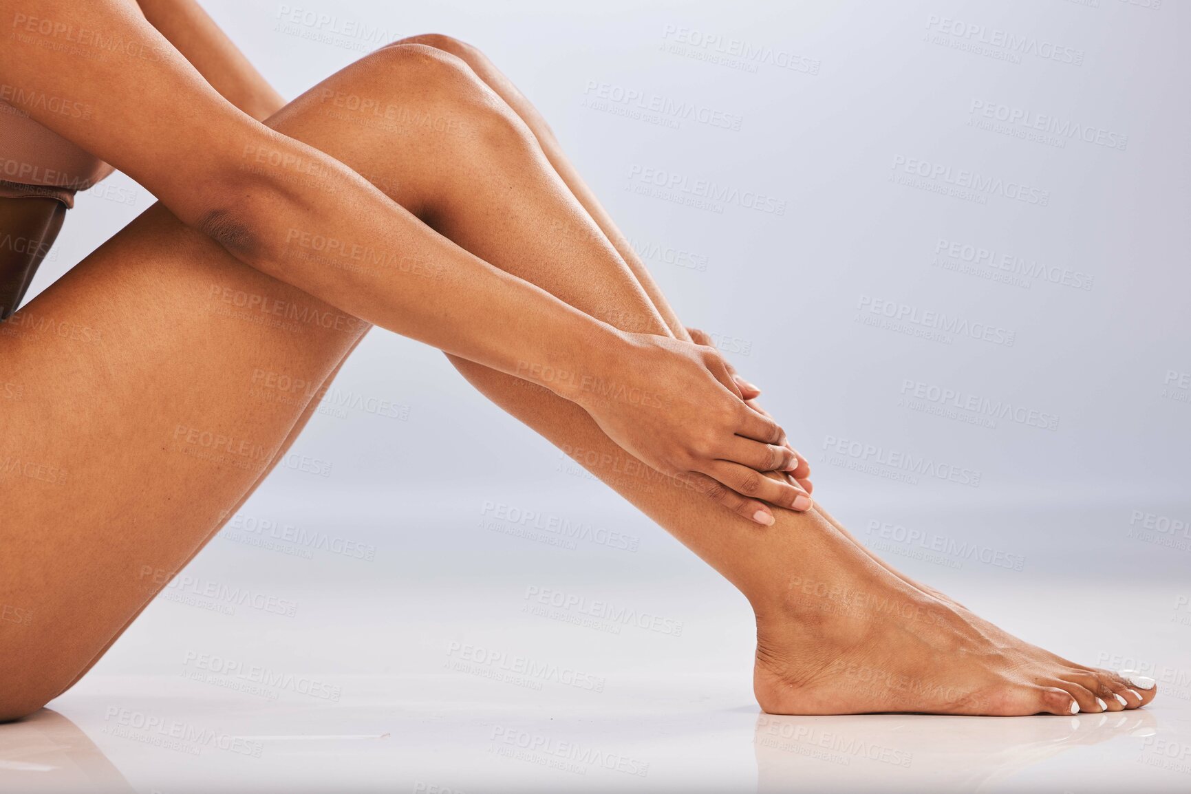 Buy stock photo Legs, feet and skin, black woman and beauty, skincare epilation and pedicure isolated on studio background. Health, wellness and grooming, waxing or laser hair removal, dermatology and cosmetic care