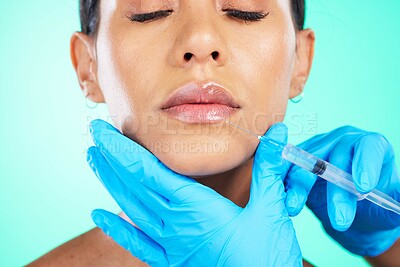 Buy stock photo Woman, face and hands with syringe for plastic surgery, lip implants or botox isolated on a studio background. Hand of doctor with needle injecting filler on female lips for facial cosmetic treatment
