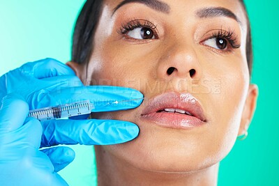 Buy stock photo Woman, face and hands with syringe for botox, plastic surgery or lip implants isolated on a studio background. Hand of doctor with needle injecting filler on female lips for facial cosmetic treatment
