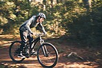 Cycling, nature and health with man in road for training, workout or cardio exercise. Adventure, extreme sports and speed with male cyclist on bike in forest park for performance, challenge or break