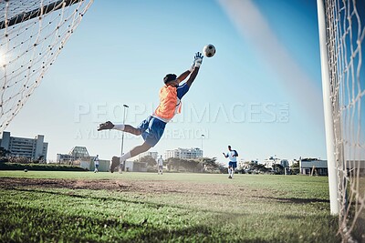 Buy stock photo Fitness, goalkeeper or soccer player taking a penalty in a game or training match at a tournament. Save, back or male football athlete kicking ball at practice on outdoor field or pitch in stadium 