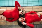 Sunglasses, swimwear and fashion women or friends in red bodysuit at indoor swimming pool. Portrait above young people relax with sports aesthetic, style and art or luxury in designer clothes