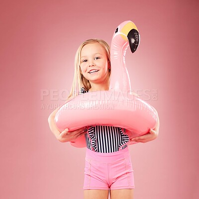 Buy stock photo Girl kid, summer and swimsuit with inflatable, flamingo and happiness with vacation on pink background. Swimwear, fun and animal toys, happy child in portrait and playful with holiday in studio