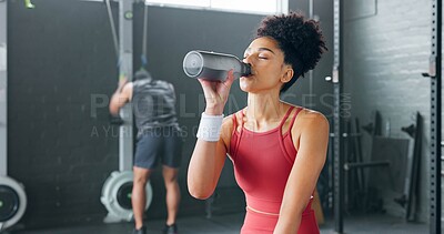 Buy stock photo Woman, fitness and drinking water on break at gym after workout, training or indoor exercise. Active or sporty female person with mineral drink in rest for diet, natural nutrition or sustainability
