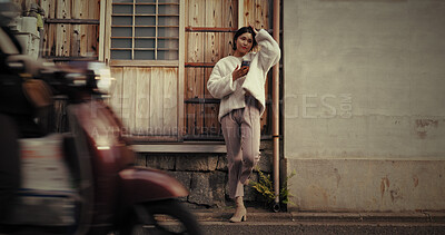 Buy stock photo Japanese woman, phone and texting in road, thinking or reading for communication, notification or app. Girl, person and smartphone with mobile network, social media and ideas on metro street in Tokyo