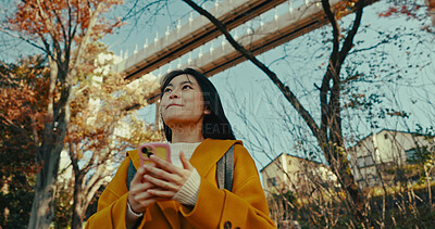 Buy stock photo Japanese woman, city and phone for technology in fashion, weekend and digital connection in urban area. Young person, smile or trendy clothes for trip on holiday adventure, tokyo town or smartphone