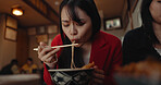 Woman, restaurant and eating ramen noodles for nutrition, gourmet dining or meal with friends. Hungry lady, chopsticks or spaghetti for lunch, dinner or Japanese cuisine, fast food diner or cafeteria