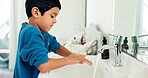 Young boy washing hands, hygiene and health with sustainability, water and routine at home. Male child in bathroom, clean with soap and foam at sink, healthy with handwashing and disinfection