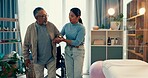 Woman, physiotherapist and senior patient with walker in elderly care for helping movement or walking at clinic. Female nurse or physio caregiver assisting mature man or person with a disability