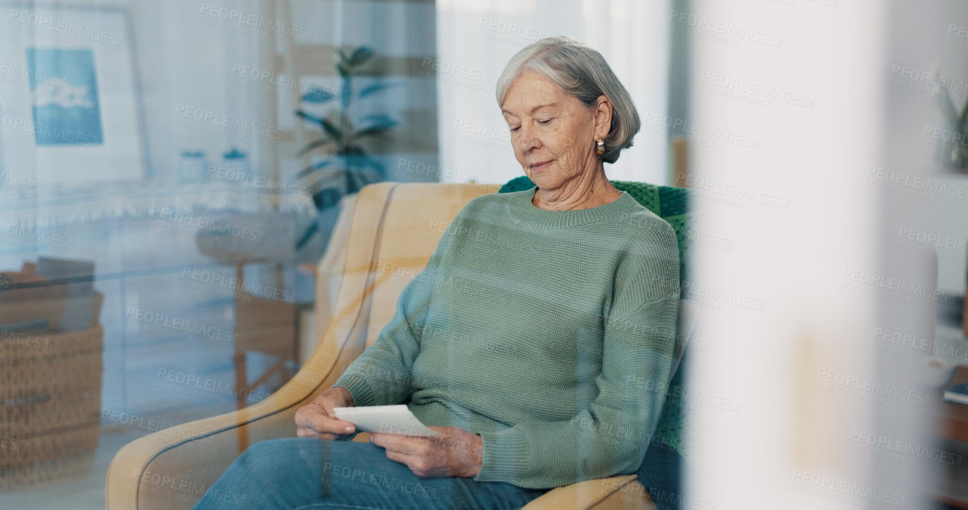 Buy stock photo Photograph, memory and senior woman in living room thinking with nostalgia or history. Remember, album and elderly female person in retirement looking at pictures on sofa in lounge at house.