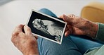 Photograph, hands and memory of a person on a home sofa for nostalgia, history and to remember. Senior adult with pictures and thinking of old album, nostalgia and wedding photography in retirement