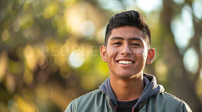 Young, man and portrait of a male laughing in a park for peace, contentment and vitality. Happy, smiling and confident latin person radiating positivity outdoors for peace, happiness and exploration